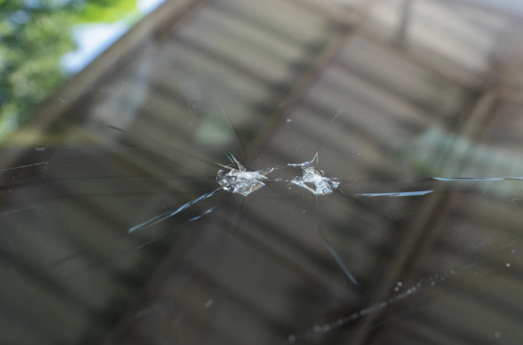 a close up photo of auto glass with a chip in it
